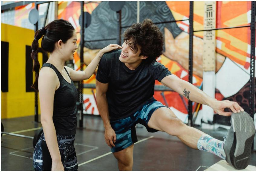 Asian couple exercising and stretching together in