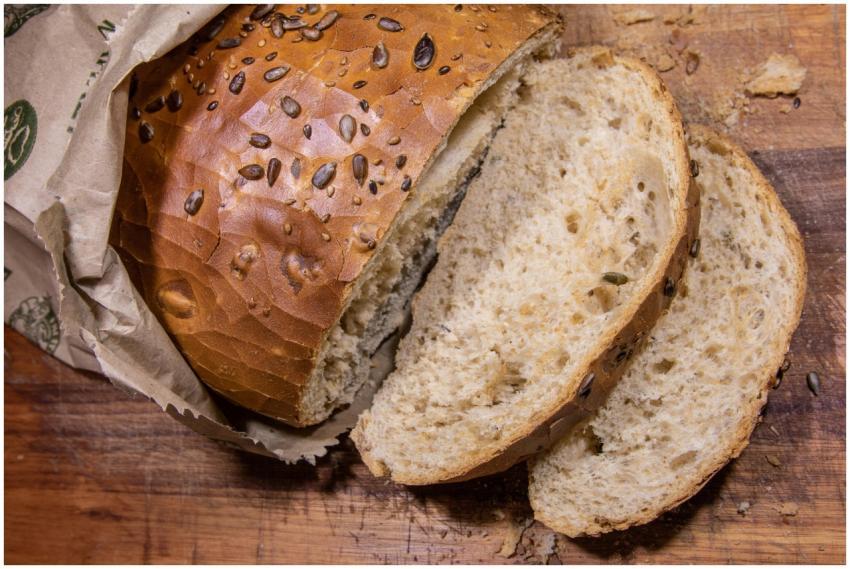 Close-up of sliced brown seeded bread on a rustic