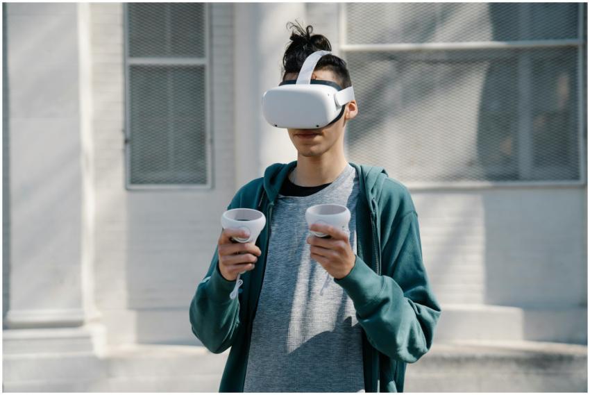 Young man with long hair in casual outfit using mo