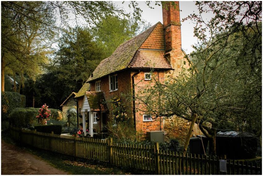 Picturesque brick cottage nestled in a lush garden