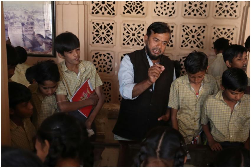 Teacher guiding attentive students during an inter