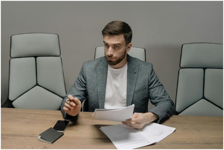 Professional businessman in a suit holding documen