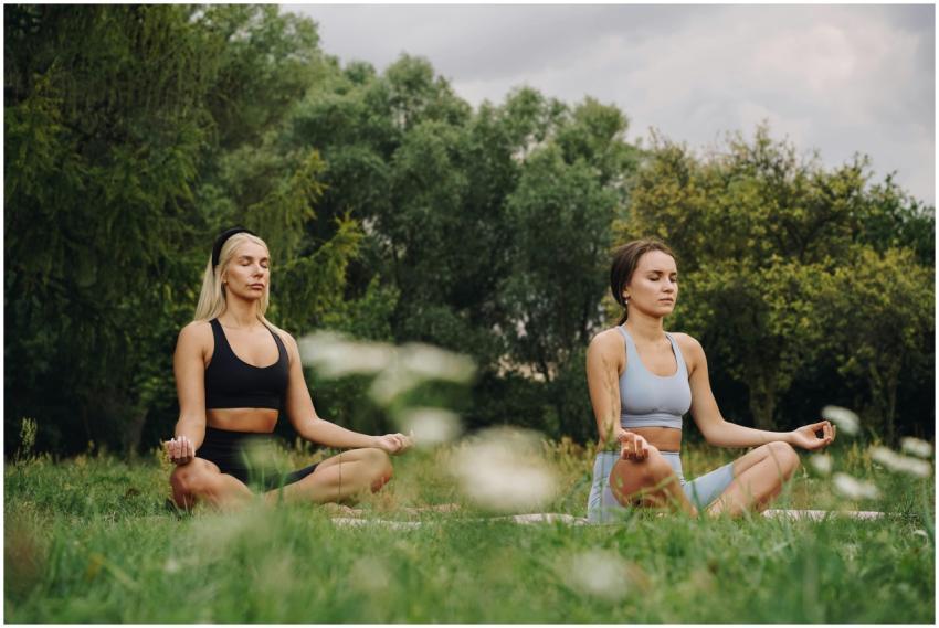 Two women practicing yoga meditation in a serene o