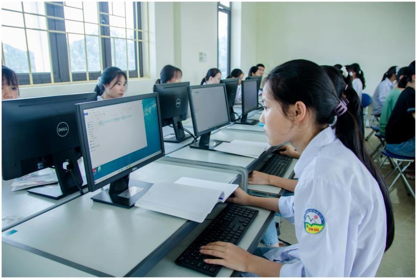 Group of Asian students working together in a comp