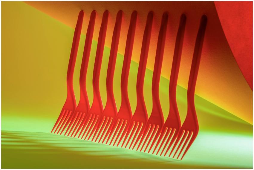 A creative arrangement of red forks on a vibrant y