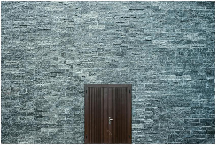 A minimalist stone brick wall featuring a simple w