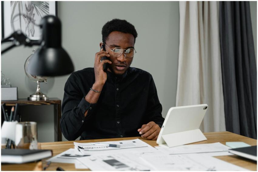 Focused man with eyeglasses making a work-related