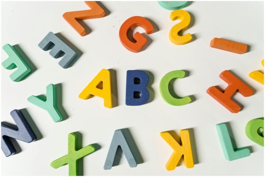 Bright, colorful wooden alphabet letters scattered