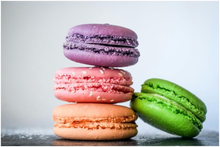 A vibrant stack of colorful macarons with sesame s