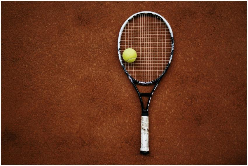 Tennis racket and ball on clay court, perfect for
