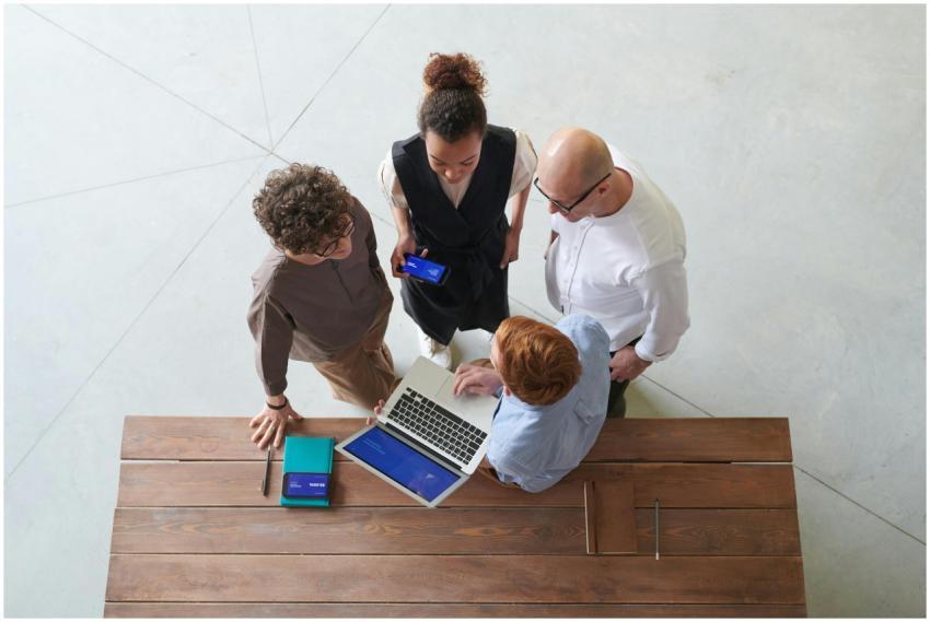 High angle view of colleagues discussing work arou