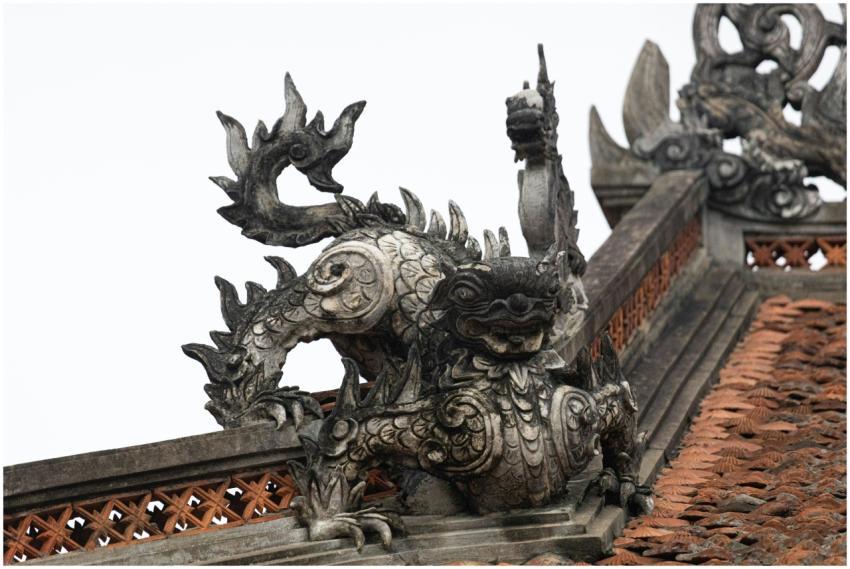Intricate dragon sculpture atop a traditional roof