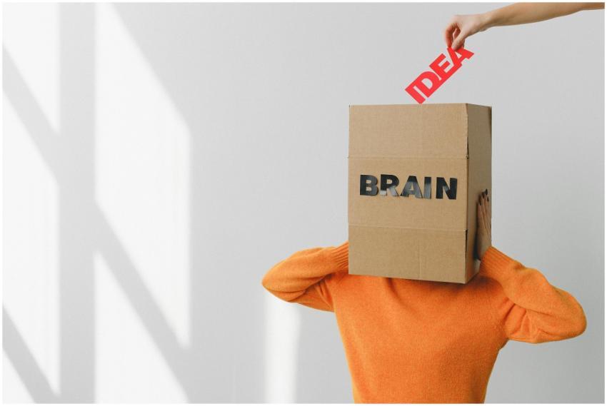 Surreal image of a person with a cardboard brain,