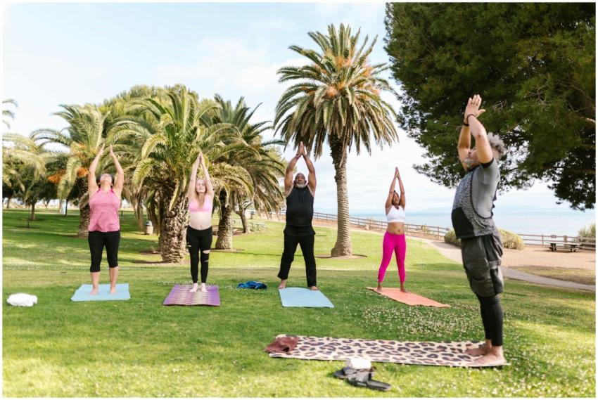 A diverse group of adults practicing yoga outdoors