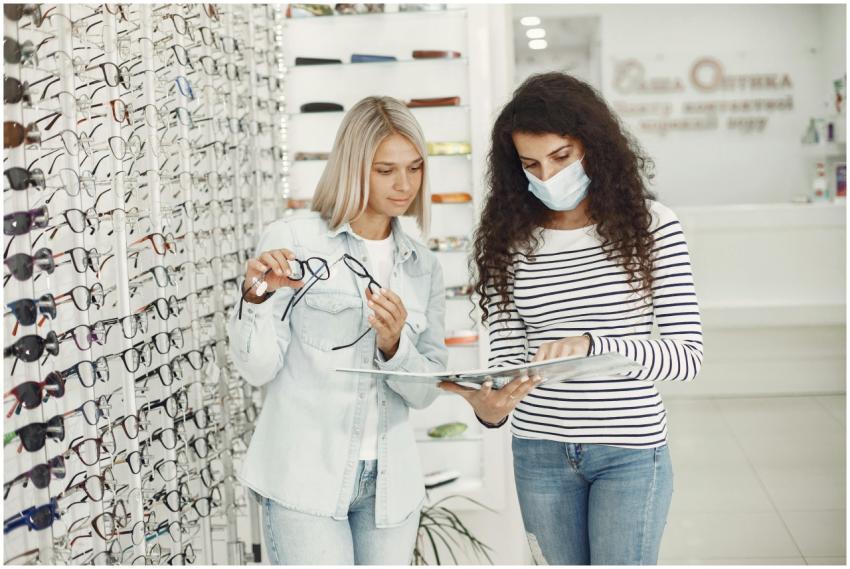 Two women examining glasses options at an optician