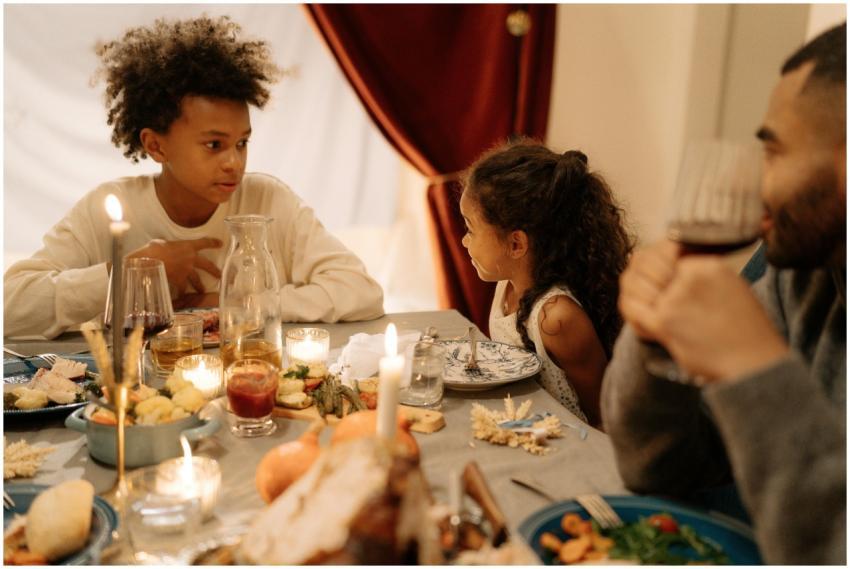 Warm family gathering around a candlelit dinner ta