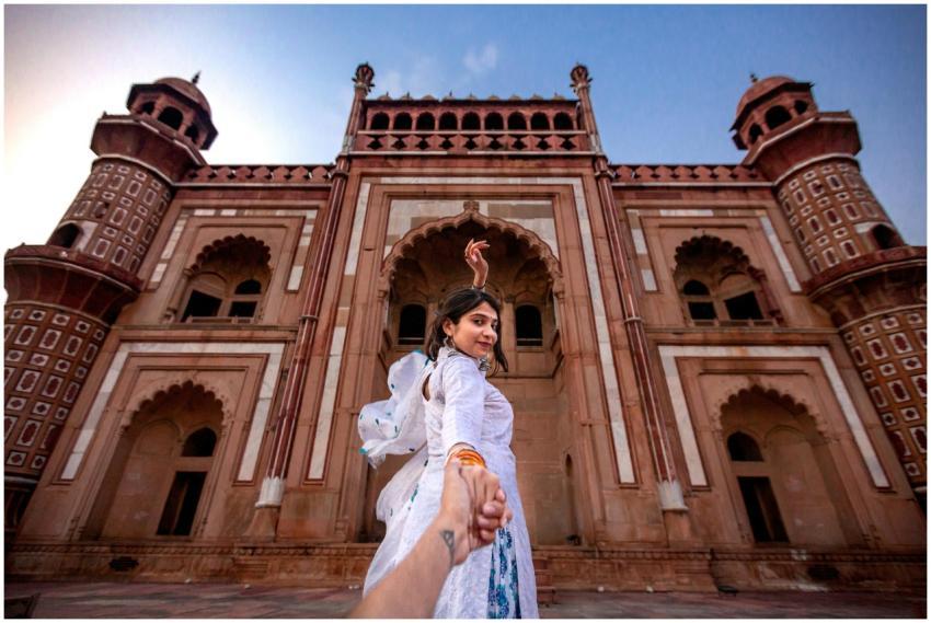 A woman poses at a famous tomb in New Delhi, showc