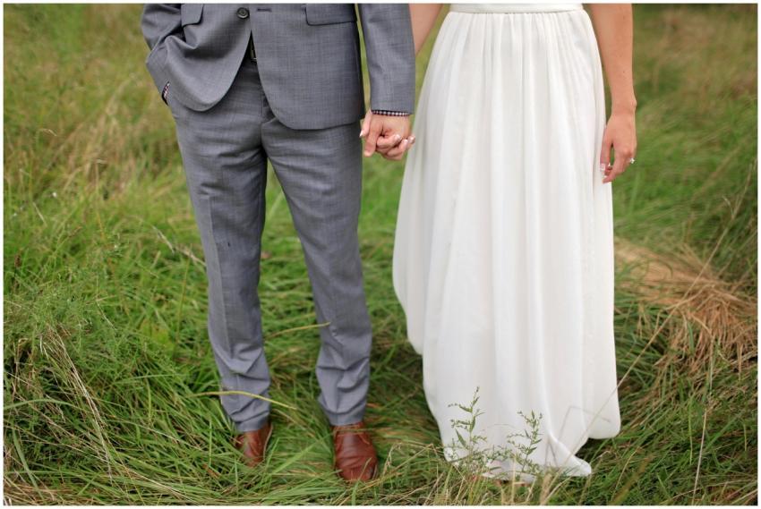 A stylish couple holds hands, showcasing elegance