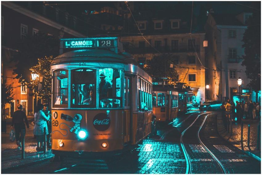 Illuminated vintage tram rides through Lisbon at n