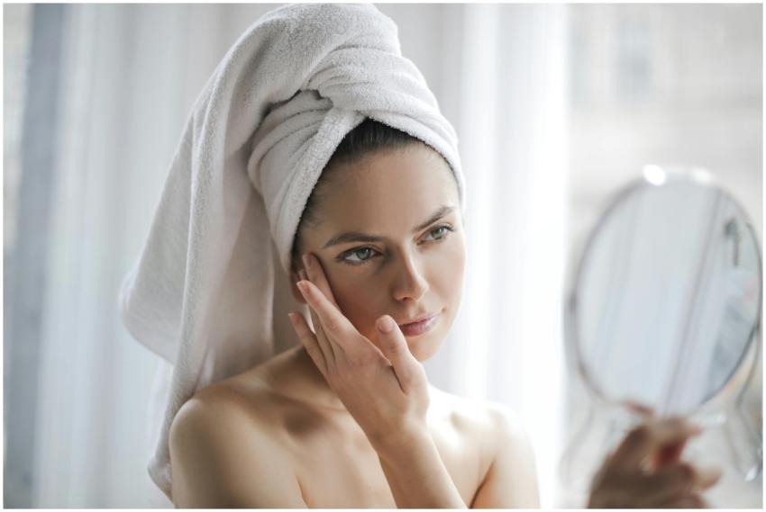 Young female with bare shoulders and towel on head