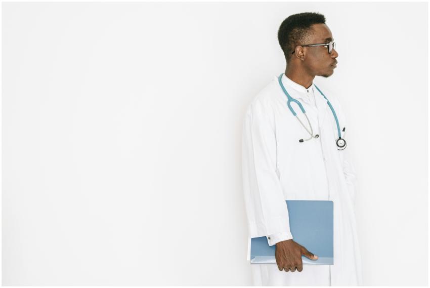 Side profile of a doctor in a medical gown holding