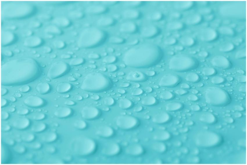 Macro shot of water droplets on a vibrant turquois