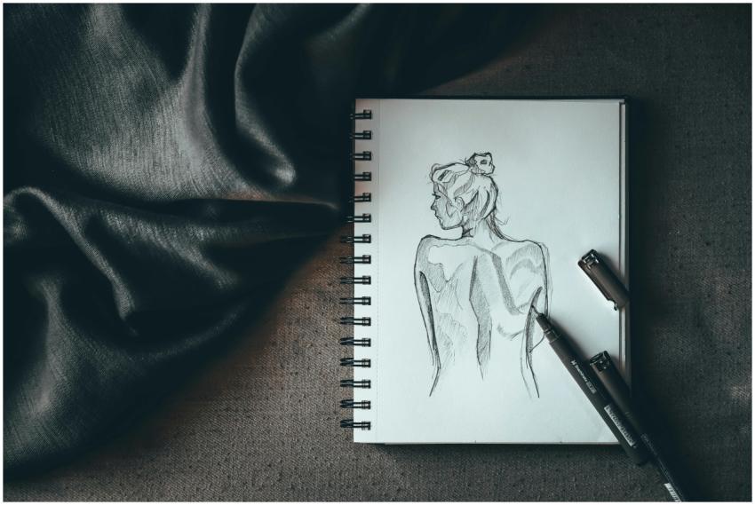 Top view composition of spiral notebook with sketc