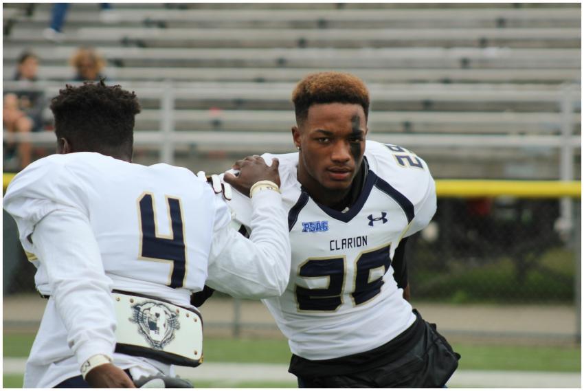 Two football players in action during practice at