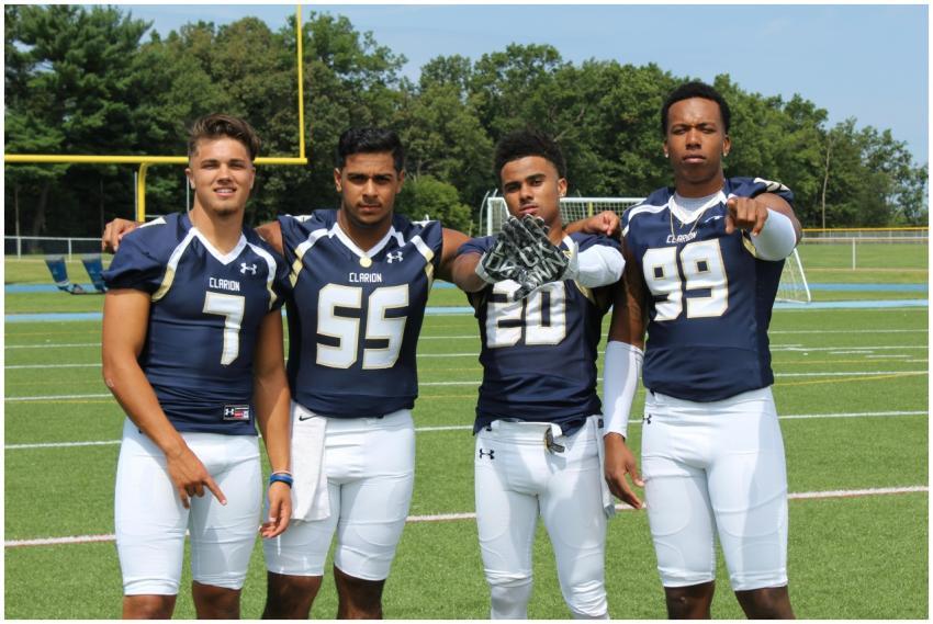 A team of young adult football players posing conf