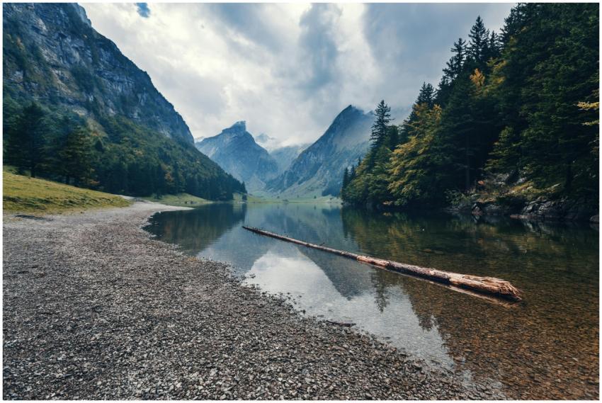 Explore the tranquil beauty of a serene lake surro