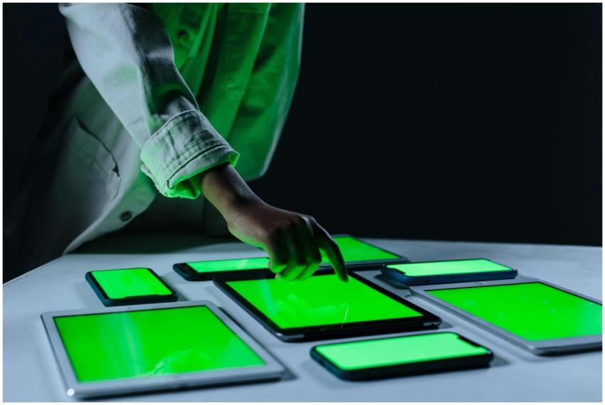 Hand interacting with multiple digital tablets on