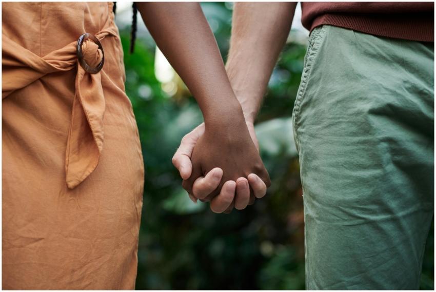 Close-up of an interracial couple holding hands in