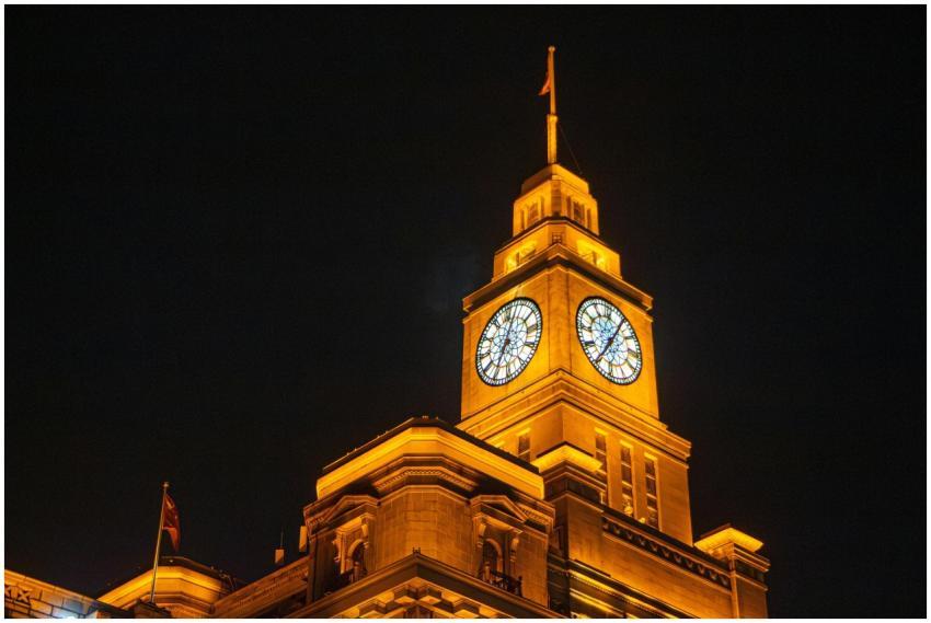 A stunning view of a brightly lit clock tower agai