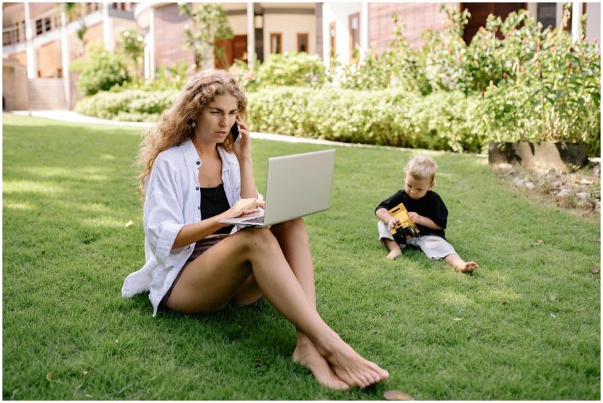 Woman working remotely on a laptop outdoors while
