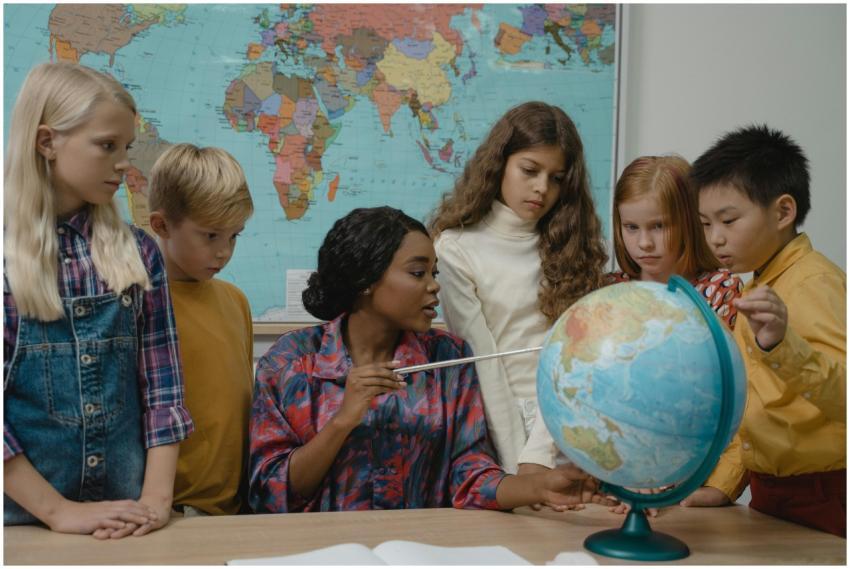 Diverse elementary students learning geography wit