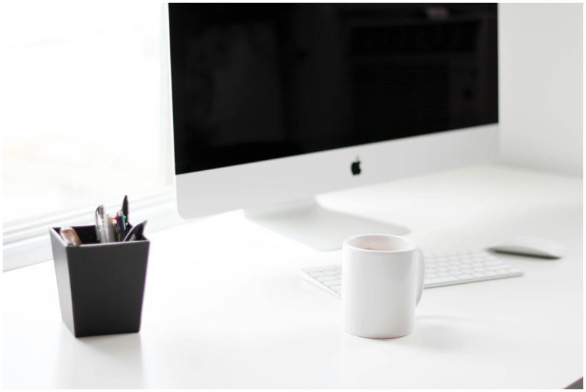 A minimalist work desk featuring a desktop compute