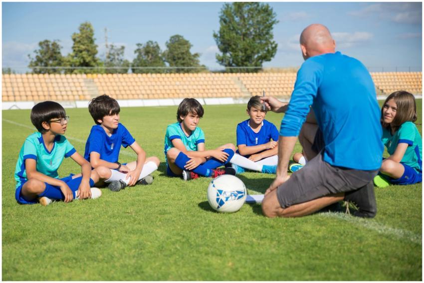 Children gather for a soccer coaching session on a