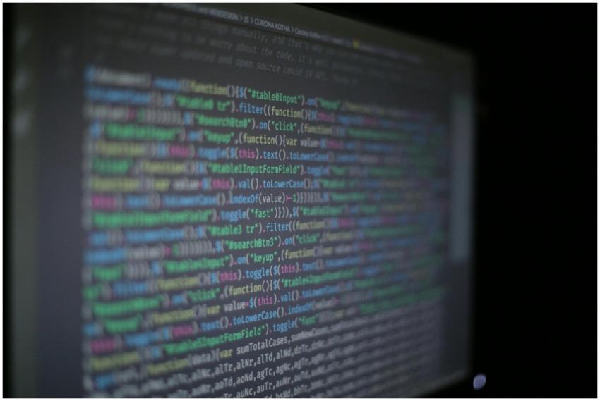 Close-up of colorful programming code on a blurred