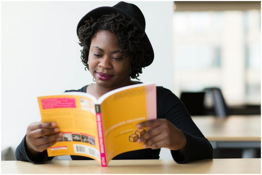 African American woman enjoying a book at a modern