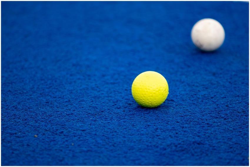 Vivid close-up of a yellow and white golf ball on