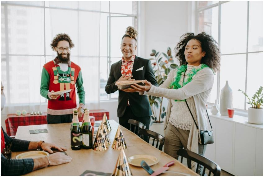 Diverse coworkers enjoy a festive office party wit