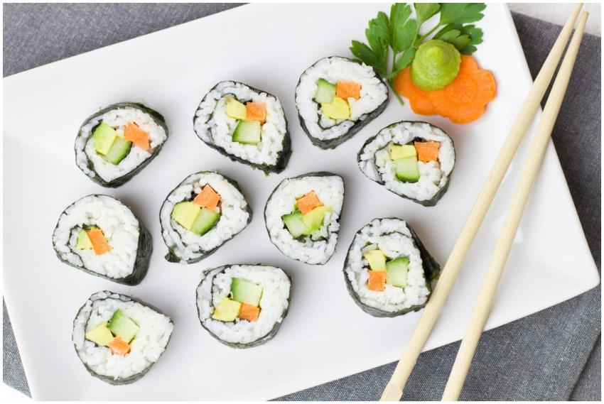 Top view of vegetable sushi rolls with chopsticks