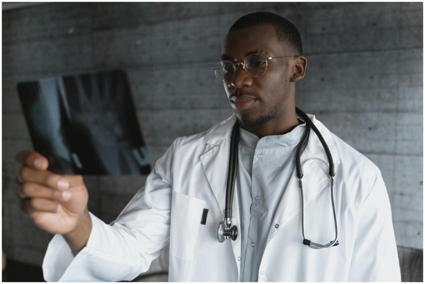 Professional doctor with eyeglasses reviewing an X