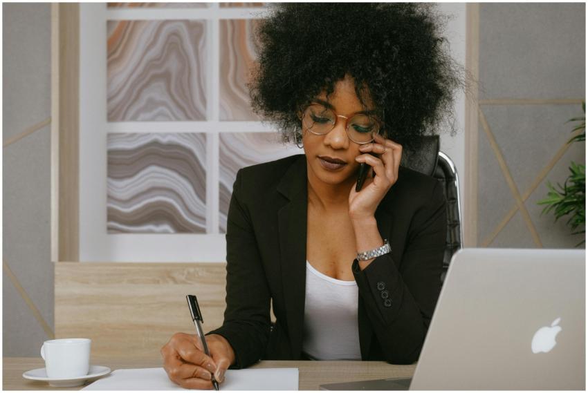 Businesswoman making a phone call while working at