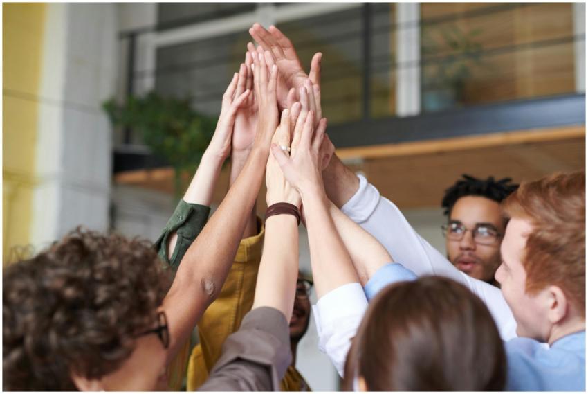 A group of diverse professionals celebrating teamw