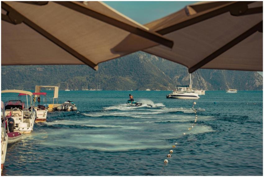 A vibrant scene of a jet ski and boats in an Aegea