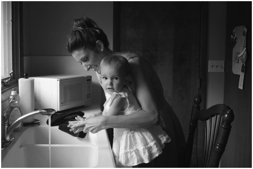 Black and white photo of a mother teaching her tod