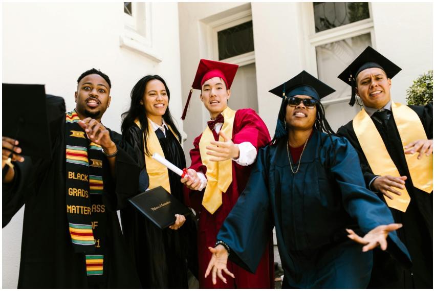 Joyful graduates in academic gowns celebrate their