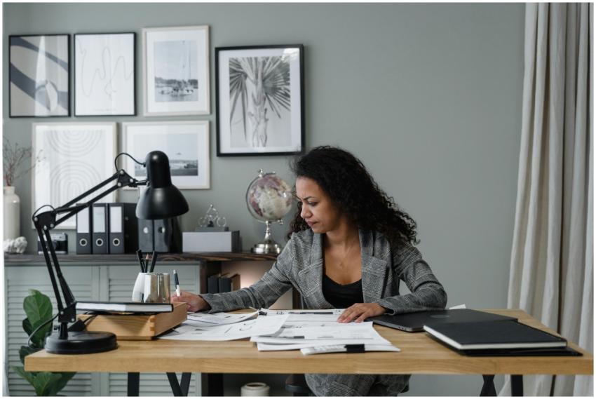 Businesswoman evaluates documents at a modern desk