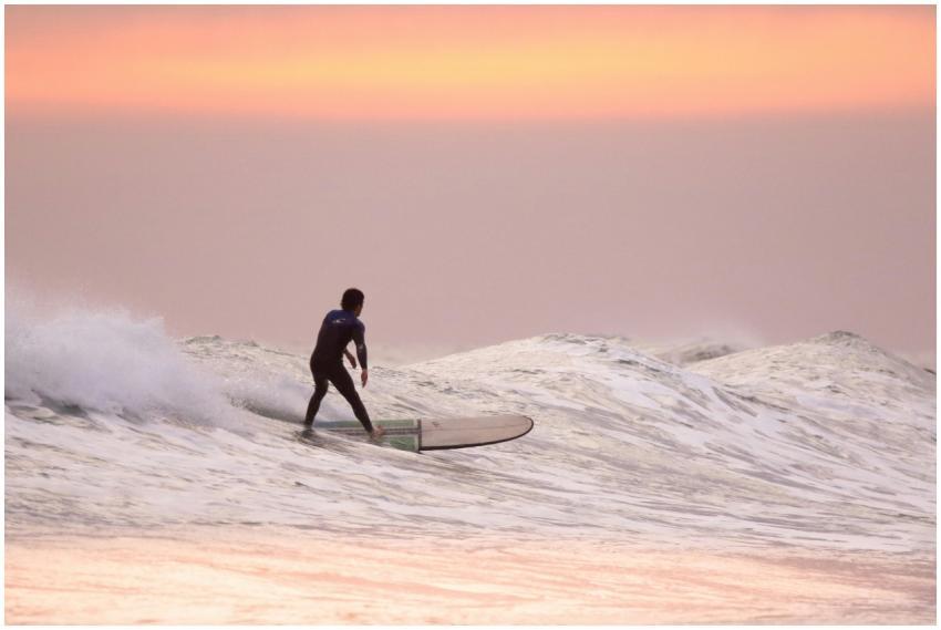 A surfer gracefully rides waves during a stunning